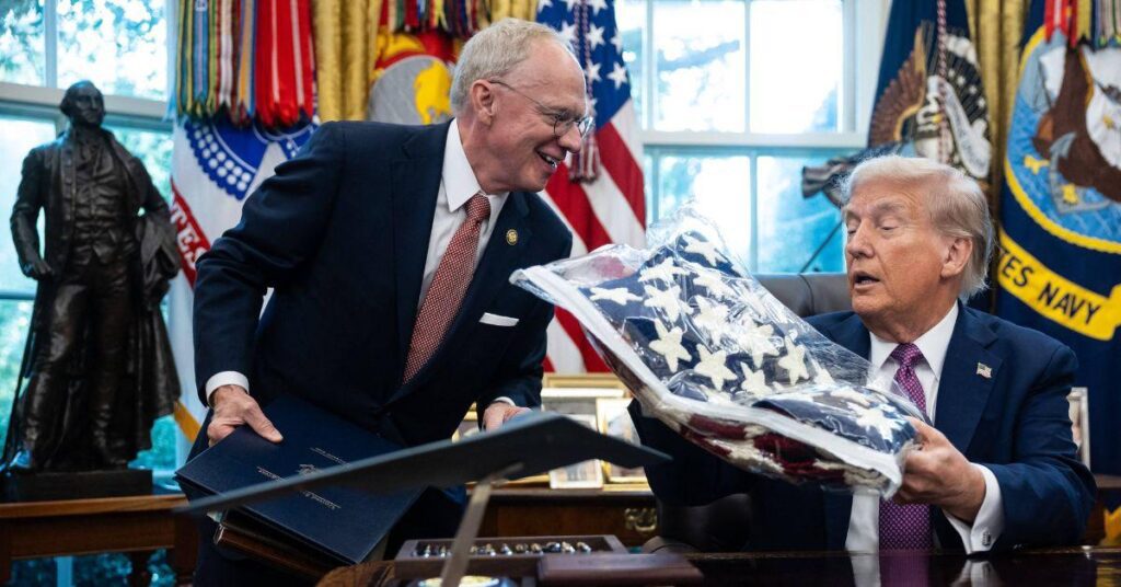 photo of Donald Trump mistook a folded American flag for a cozy blanket