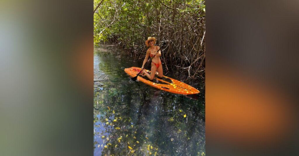 Image of Brie Larson went paddleboarding on a lake.
