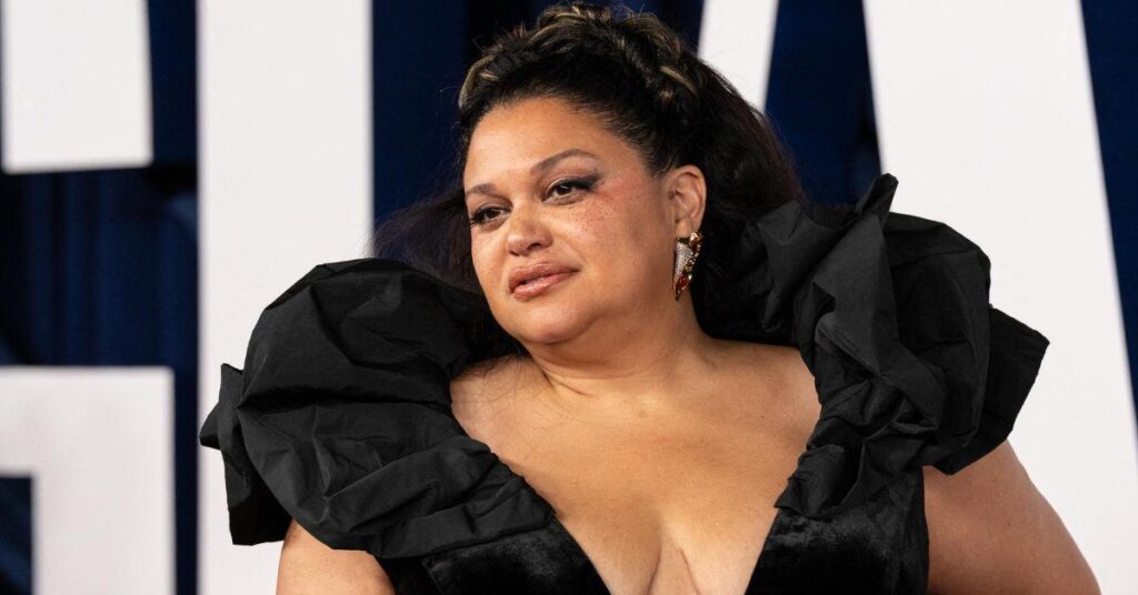 Image of Lenny Kravitz kissed Michelle Buteau's hand.