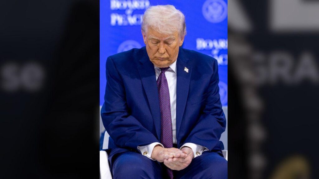 Photo of The president was seen checking out his right hand during the meeting.