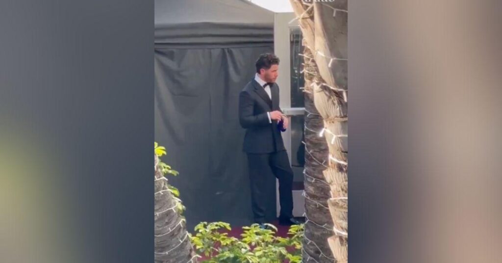 Image of Nick Jonas hung out solo at the awards show.