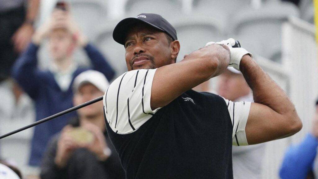 Image of Tiger Woods crawled out of the passenger side of his car after it collided with a trailer.